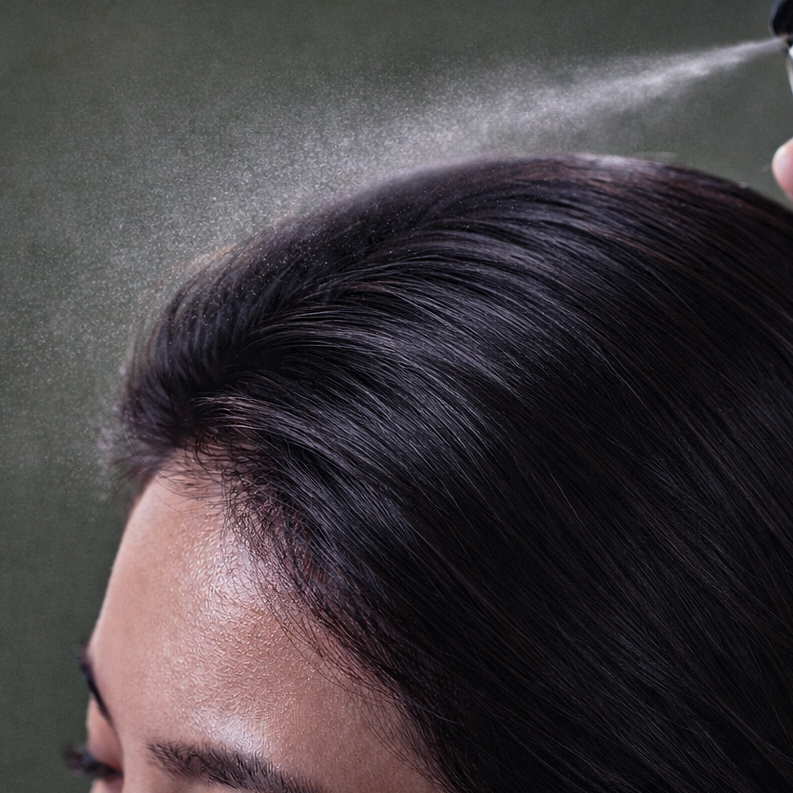 Person using scalp hair mist